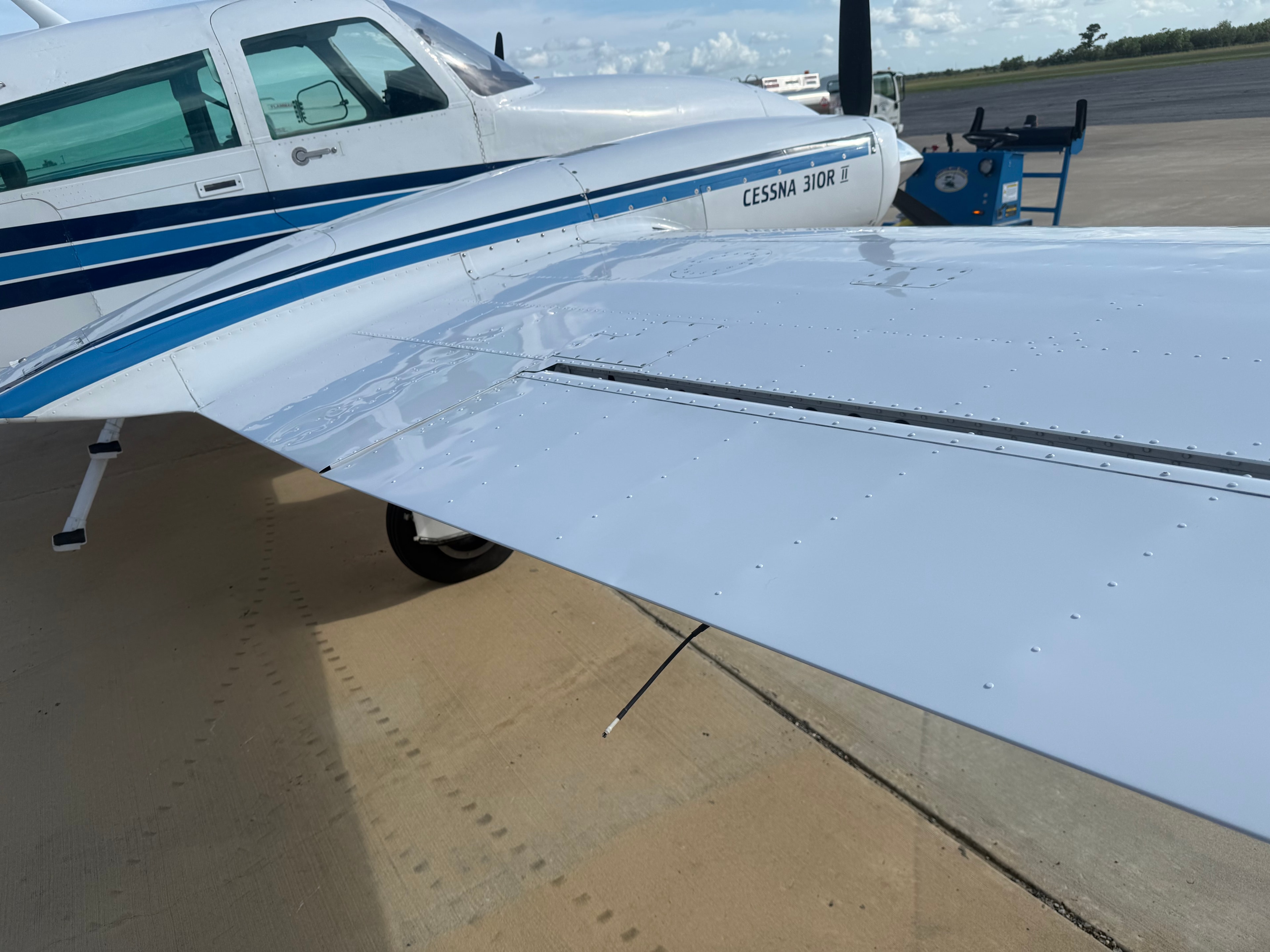 Polished Cessna 310R wing and fuselage on airport tarmac