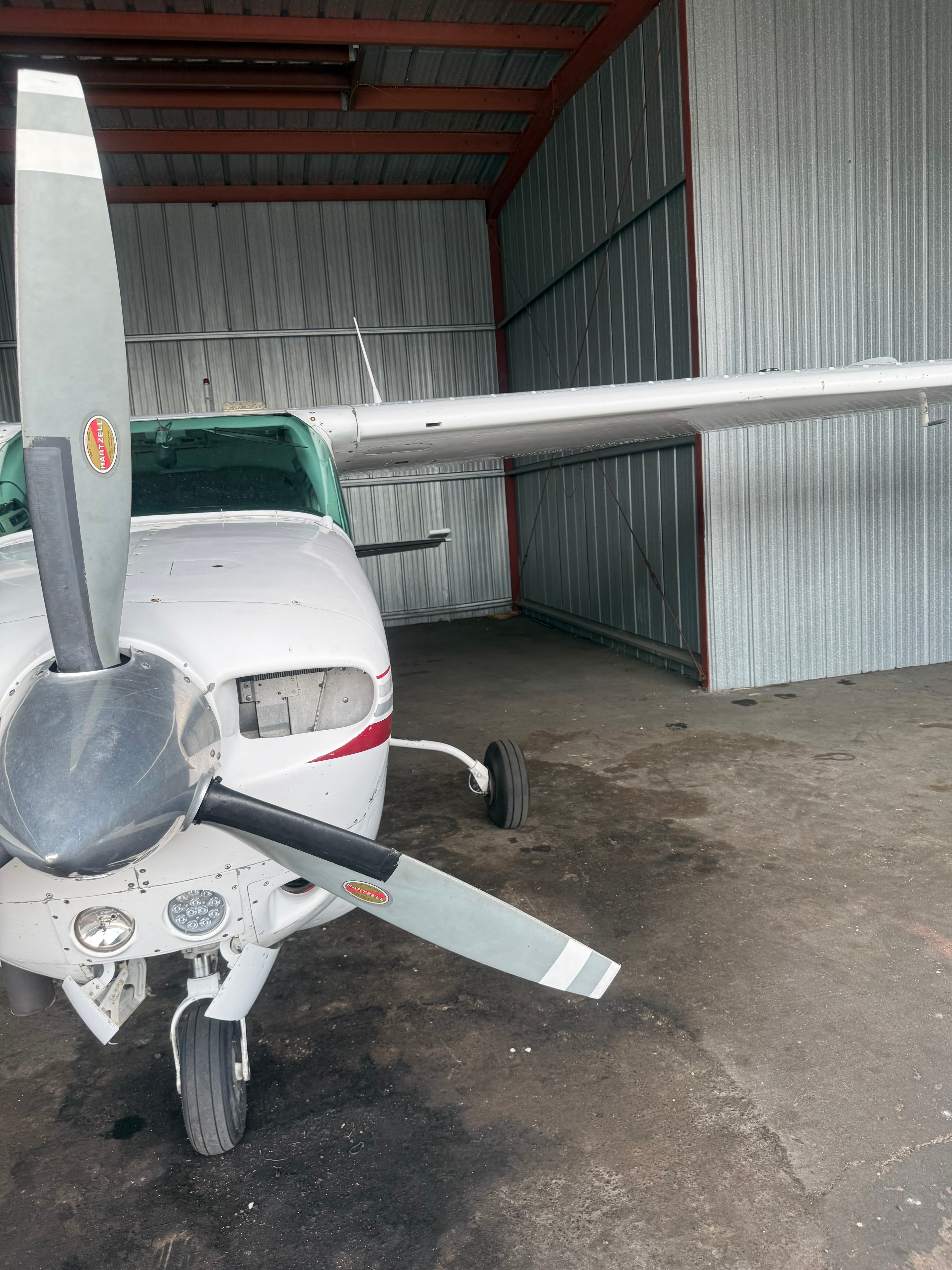 Close-up of Cessna aircraft propeller and nose in hangar